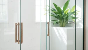 Modern bathroom featuring glass shower doors with sleek design and polished handles.